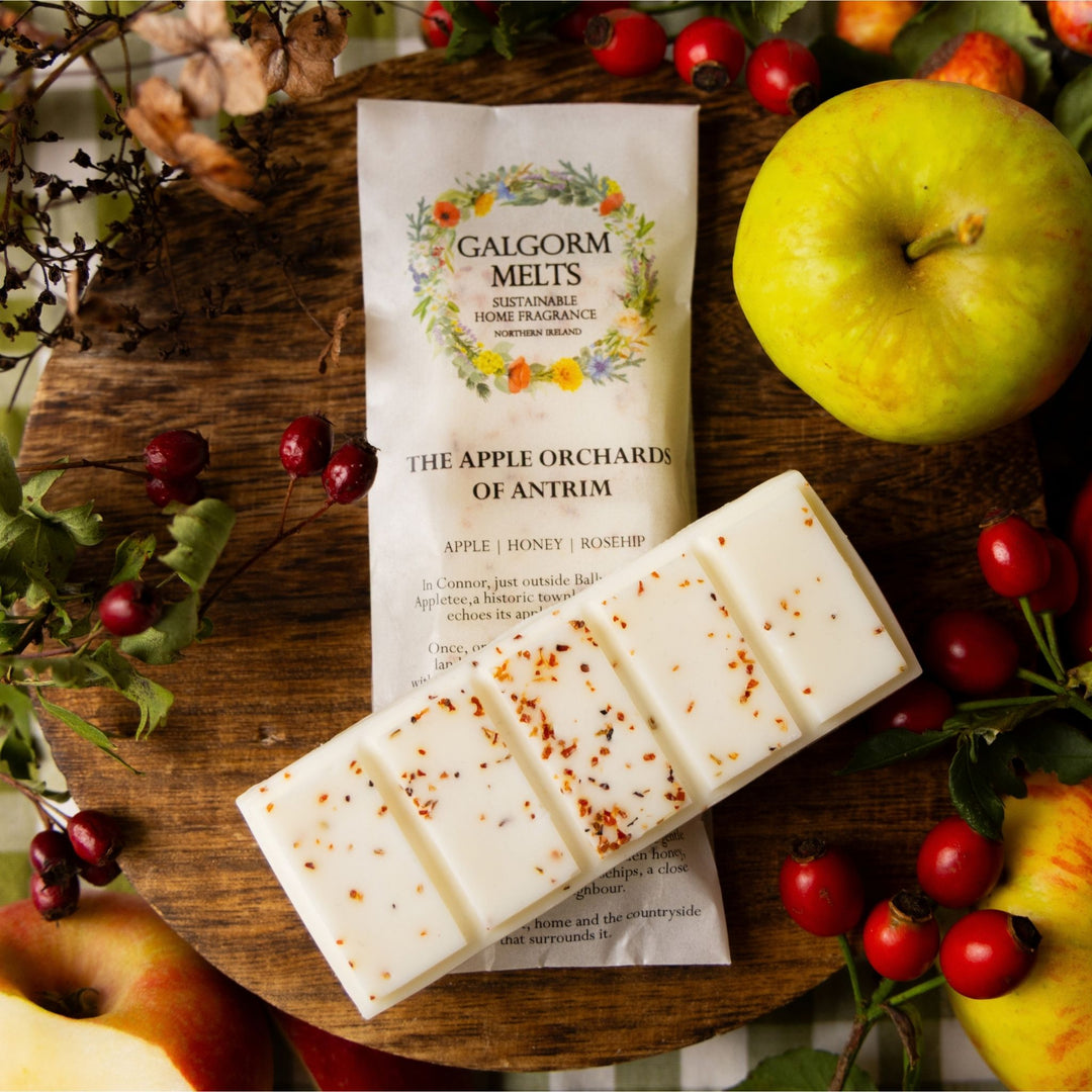 The Apple Orchards of Antrim soy wax melt. Surrounded by seasonal fruits and berries.